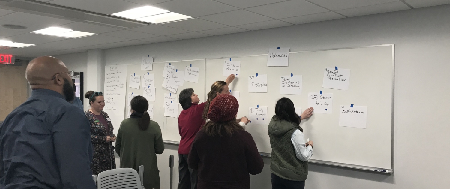 people strategizing using a whiteboard