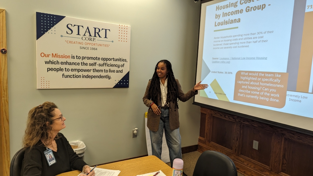 Picture of woman pointing to a projector screen